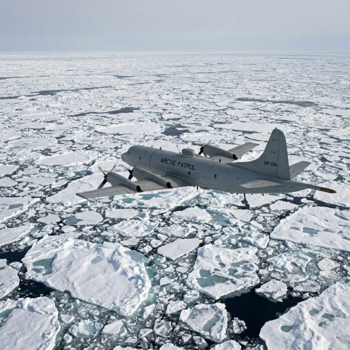 Arctic patrol aircraft flying over fragmented sea ice in icy waters